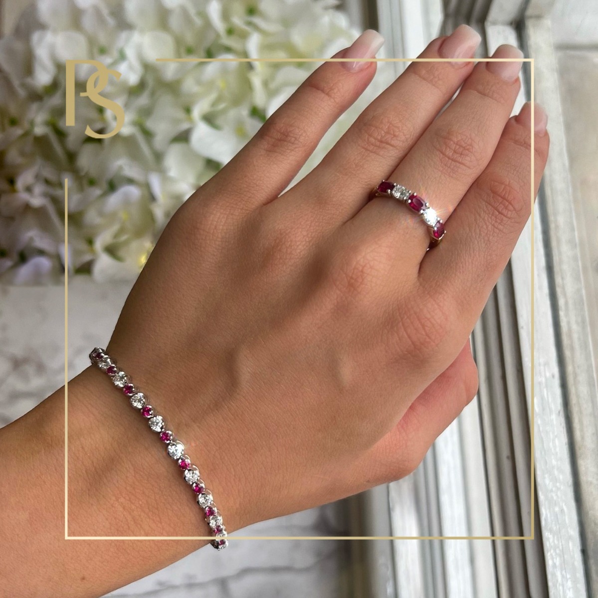 Ruby ring and bracelet worn on a hand